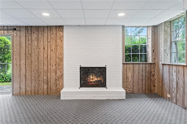 870 Richmond Hill Dr, Marietta, GA 30068 - unfurnished living room with carpet, wooden walls, a drop ceiling, a fireplace, and recessed lighting