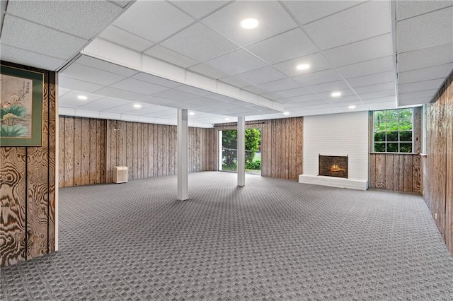 870 Richmond Hill Dr, Marietta, GA 30068 - basement featuring wooden walls, carpet floors, and a large fireplace