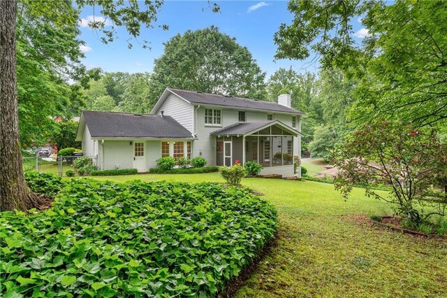 870 Richmond Hill Dr, Marietta, GA 30068 - back of house with a sunroom, a chimney, and a yard