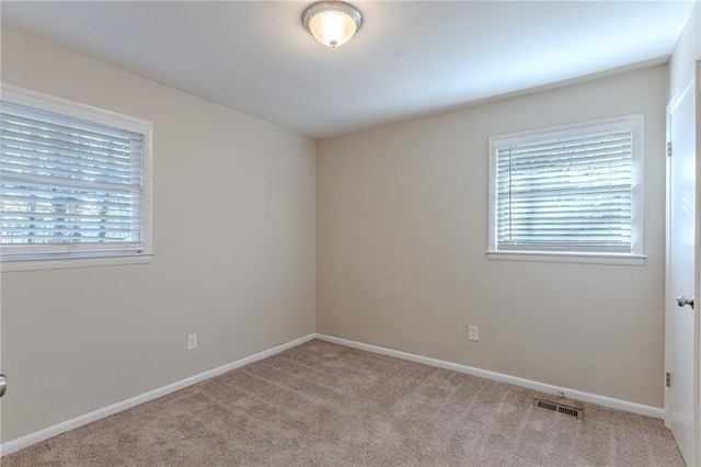 unfurnished room with light colored carpet