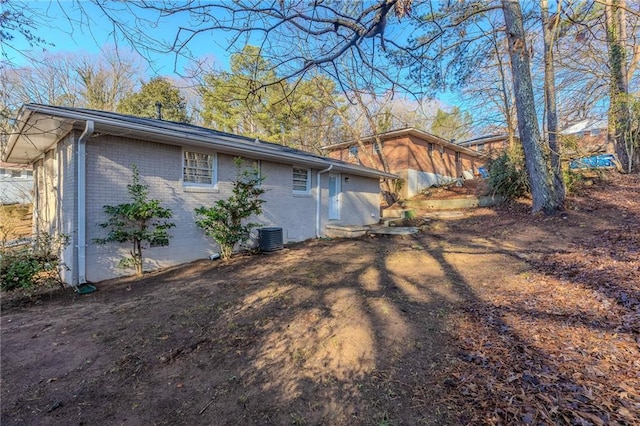 view of side of home with central AC