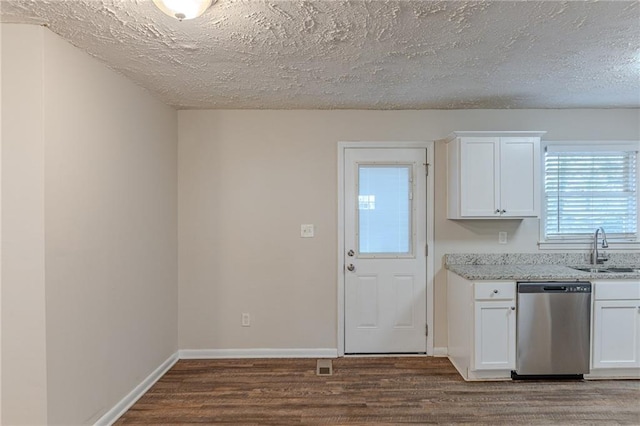 kitchen with white cabinetry, sink, stainless steel dishwasher, light stone counters, and dark wood-type flooring