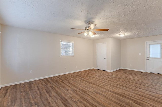 empty room featuring ceiling fan, wood-type flooring, and a textured ceiling