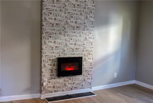 room details featuring a fireplace and hardwood / wood-style floors