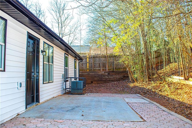 view of patio / terrace with central AC unit and fence