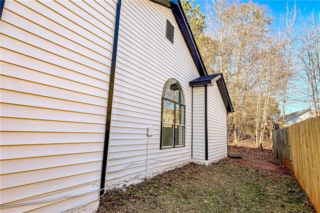 view of home's exterior with fence