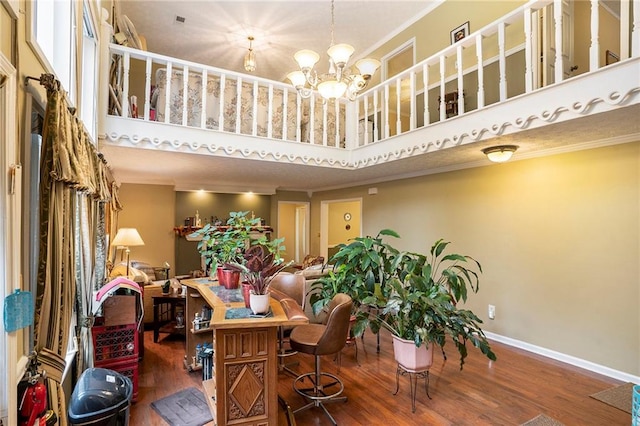 dining space with crown molding, a towering ceiling, and dark hardwood / wood-style floors