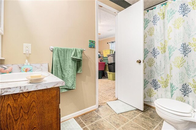 bathroom featuring vanity, toilet, tile patterned floors, and a textured ceiling