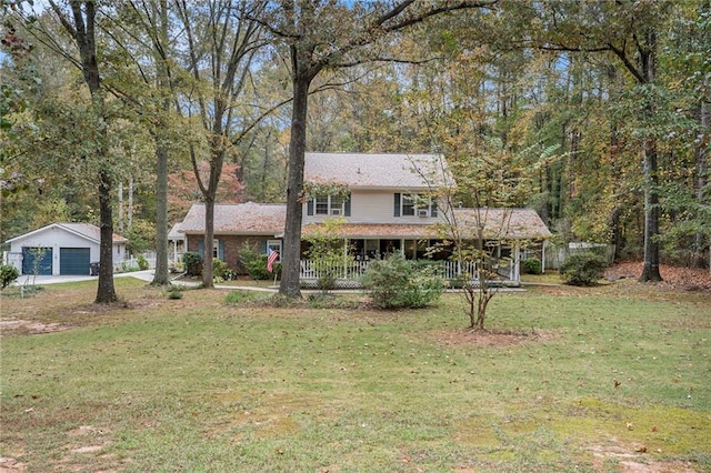 view of front of house with an outbuilding and a front lawn