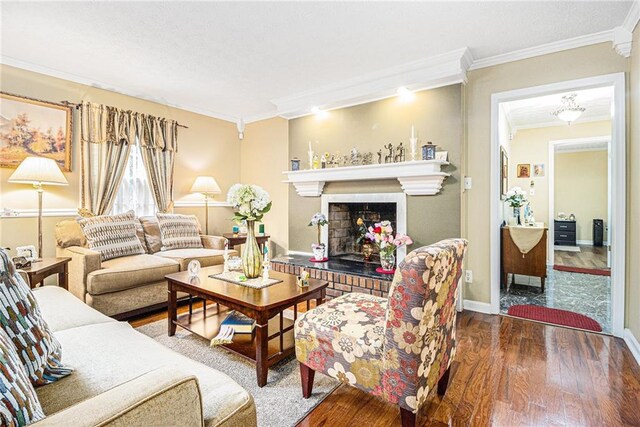 living room featuring hardwood / wood-style floors, a brick fireplace, and crown molding