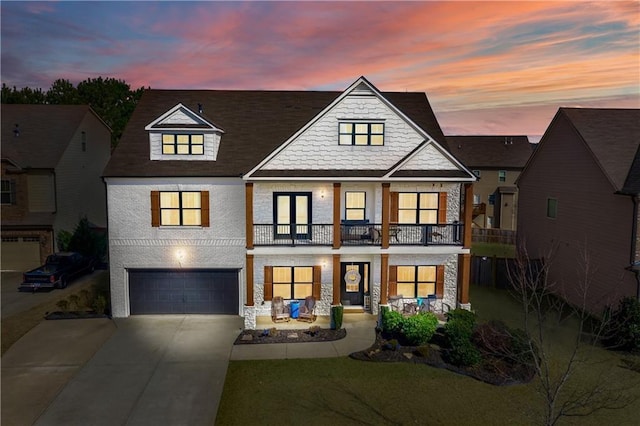 view of front of property featuring a garage and a balcony