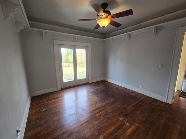 empty room with ceiling fan and dark hardwood / wood-style floors