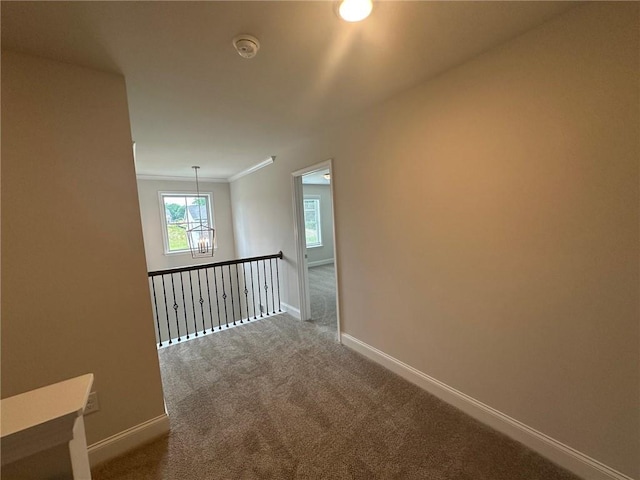 2180 Highridge Point Dr, Lithia Springs, GA 30122 - hall with baseboards, carpet flooring, and a chandelier