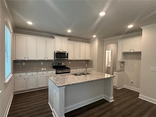 2180 Highridge Point Dr, Lithia Springs, GA 30122 - kitchen with appliances with stainless steel finishes, a sink, ornamental molding, white cabinetry, and dark wood finished floors
