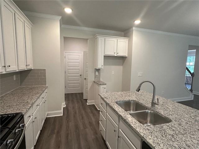 2180 Highridge Point Dr, Lithia Springs, GA 30122 - kitchen with a sink, gas stove, crown molding, dark wood-style flooring, and white cabinetry