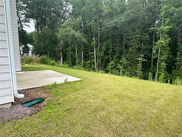 2180 Highridge Point Dr, Lithia Springs, GA 30122 - view of grassy yard with a patio area and a wooded view