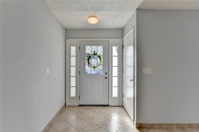 tiled entrance foyer featuring a textured ceiling