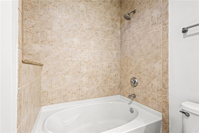 bathroom with toilet and bathtub / shower combination