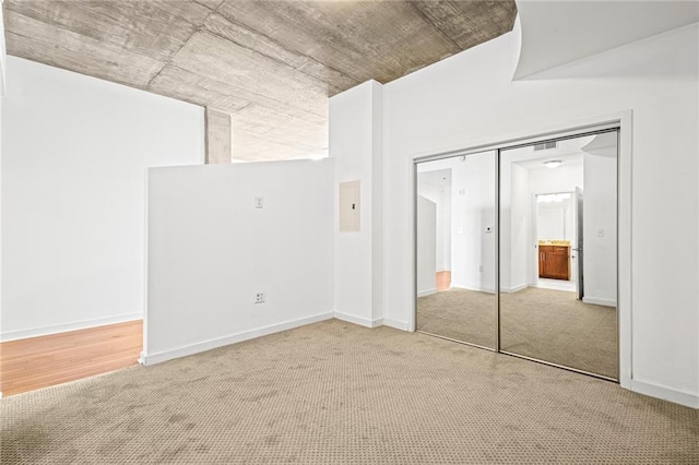 unfurnished bedroom with carpet flooring and a closet