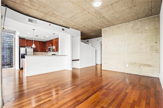 unfurnished living room featuring wood finished floors