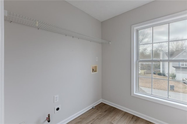 washroom featuring laundry area, baseboards, hookup for a gas dryer, hookup for a washing machine, and hookup for an electric dryer