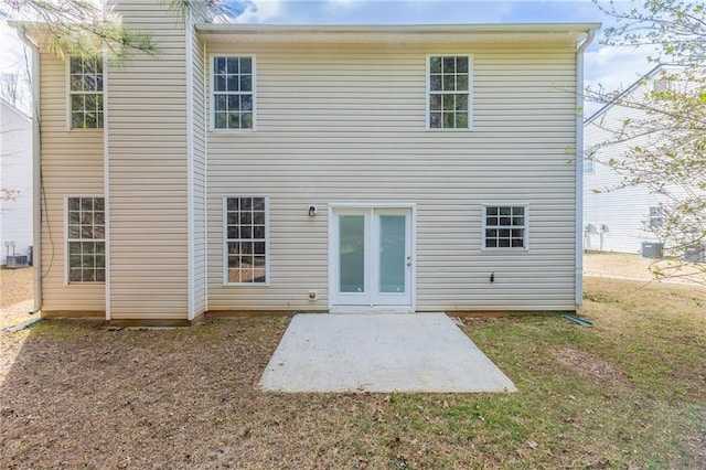 back of house featuring a patio area and a yard