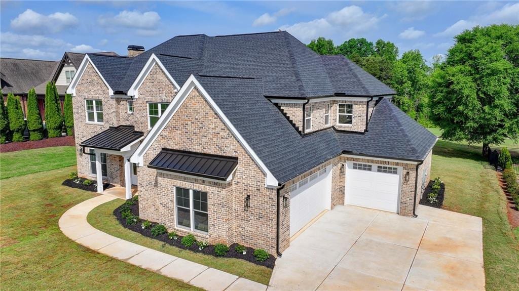 view of front of home with a garage and a front yard