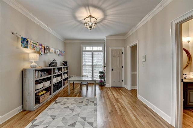 office space with light wood-type flooring, baseboards, a chandelier, and crown molding