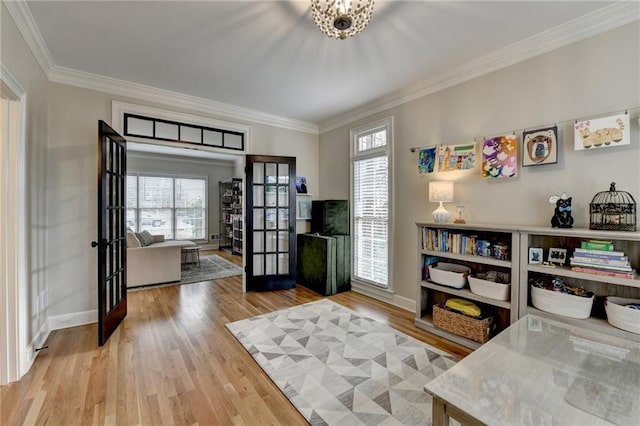 home office with ornamental molding, french doors, baseboards, and wood finished floors