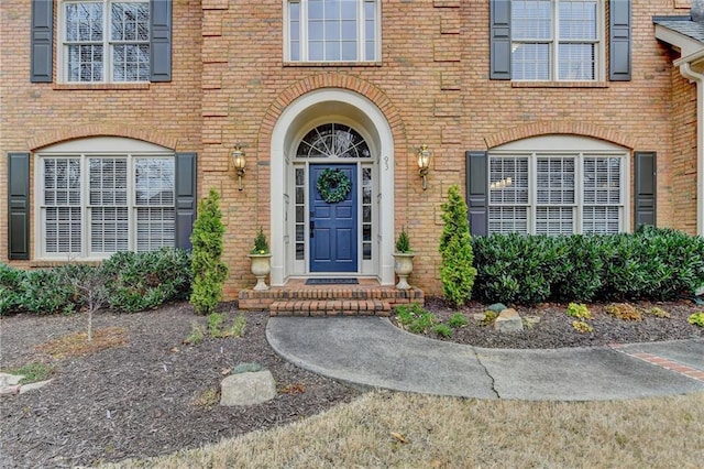 entrance to property featuring brick siding