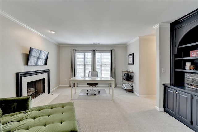 office with a fireplace with flush hearth, crown molding, and light colored carpet