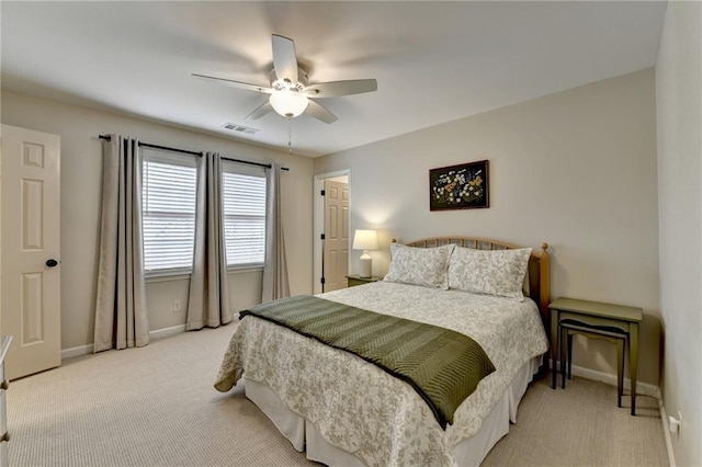 carpeted bedroom featuring ceiling fan, visible vents, and baseboards