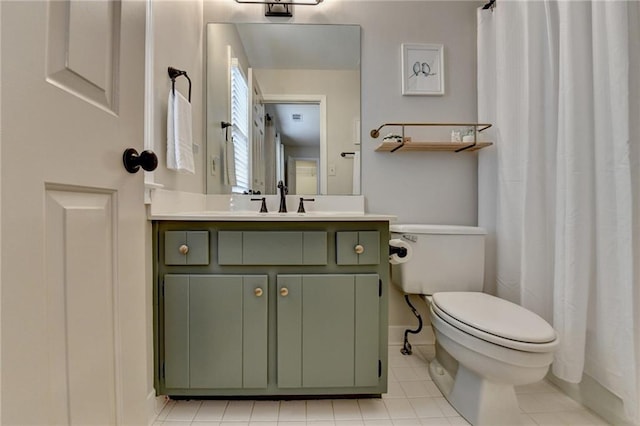 full bathroom with curtained shower, tile patterned flooring, toilet, vanity, and baseboards