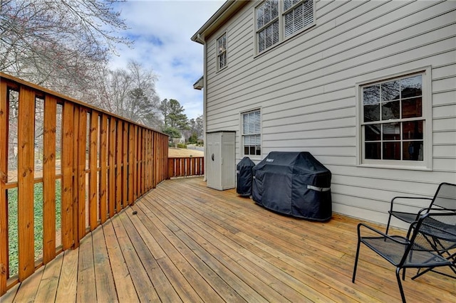 wooden terrace with a grill