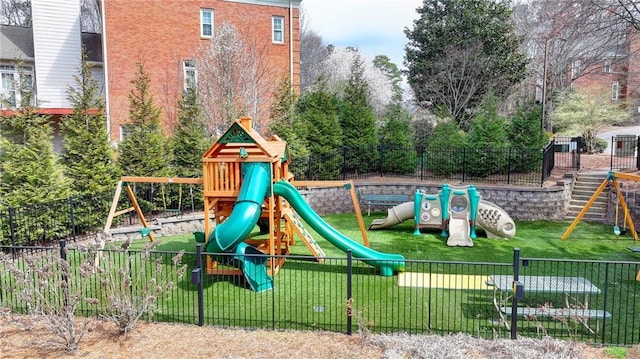 view of playground featuring a yard and fence