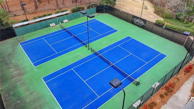 view of sport court featuring fence