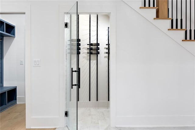 stairs with hardwood / wood-style floors