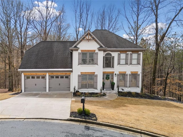 view of front of house with stucco siding, driveway, roof with shingles, a front yard, and an attached garage