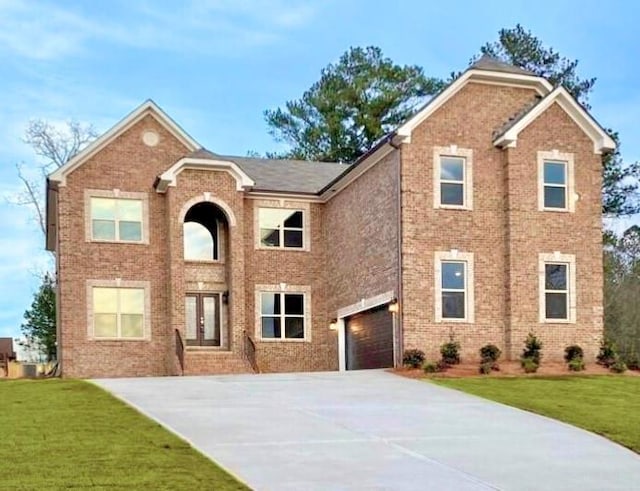 traditional-style home with an attached garage, french doors, brick siding, driveway, and a front yard