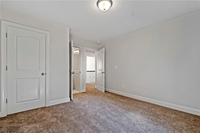 unfurnished bedroom with carpet and baseboards