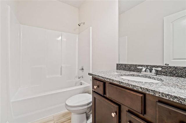 bathroom featuring shower / bathing tub combination, vanity, and toilet