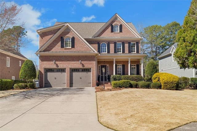 view of front of property featuring brick siding, covered porch, driveway, and a front yard