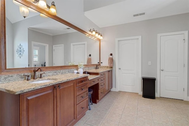 bathroom featuring visible vents, double vanity, a sink, crown molding, and tile patterned floors