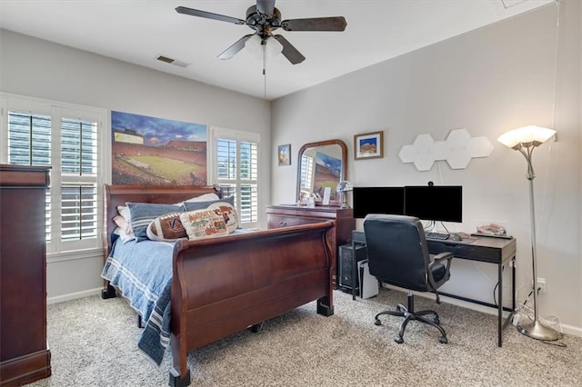 carpeted bedroom with visible vents, ceiling fan, and baseboards