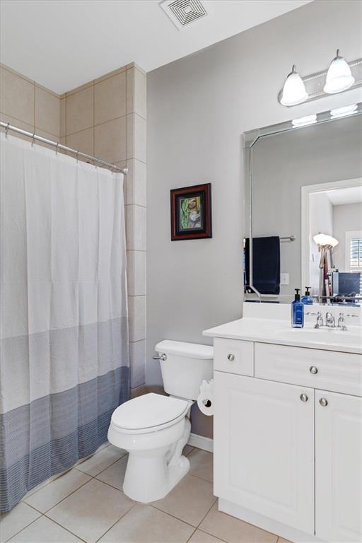 full bathroom featuring tile patterned floors, visible vents, toilet, and vanity