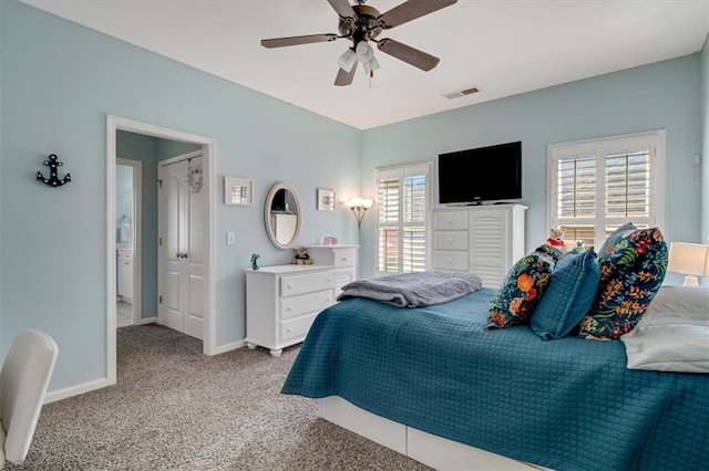 carpeted bedroom featuring visible vents, baseboards, and ceiling fan