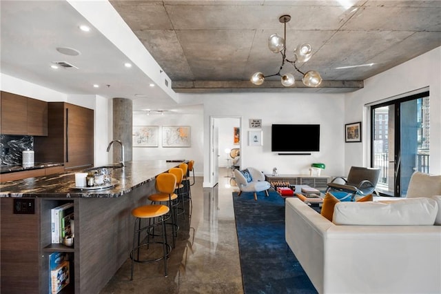 living room with visible vents and concrete floors