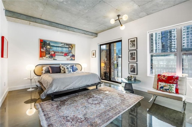 bedroom featuring multiple windows, baseboards, and concrete flooring