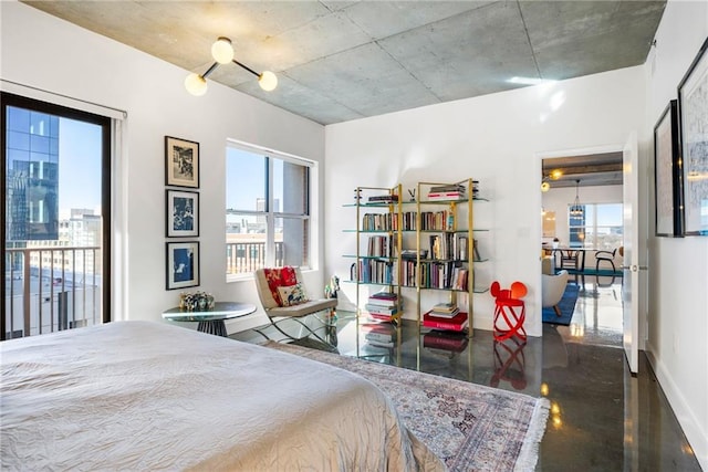 bedroom with finished concrete flooring, access to outside, and baseboards