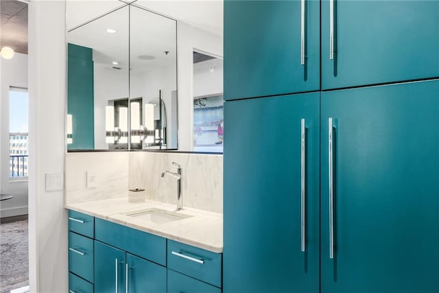 bathroom with vanity and decorative backsplash